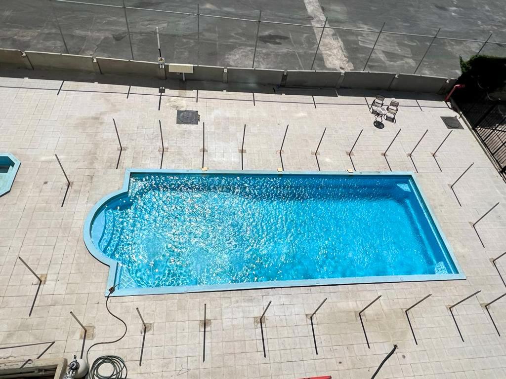 an overhead view of a blue swimming pool at Urban Luxury Apartment in Jeddah