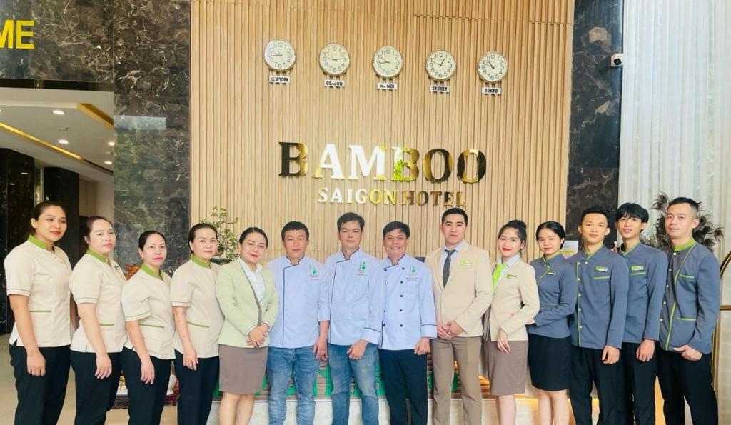 a group of people standing in front of a building at Khách sạn Bamboo Sài gòn in Ho Chi Minh City