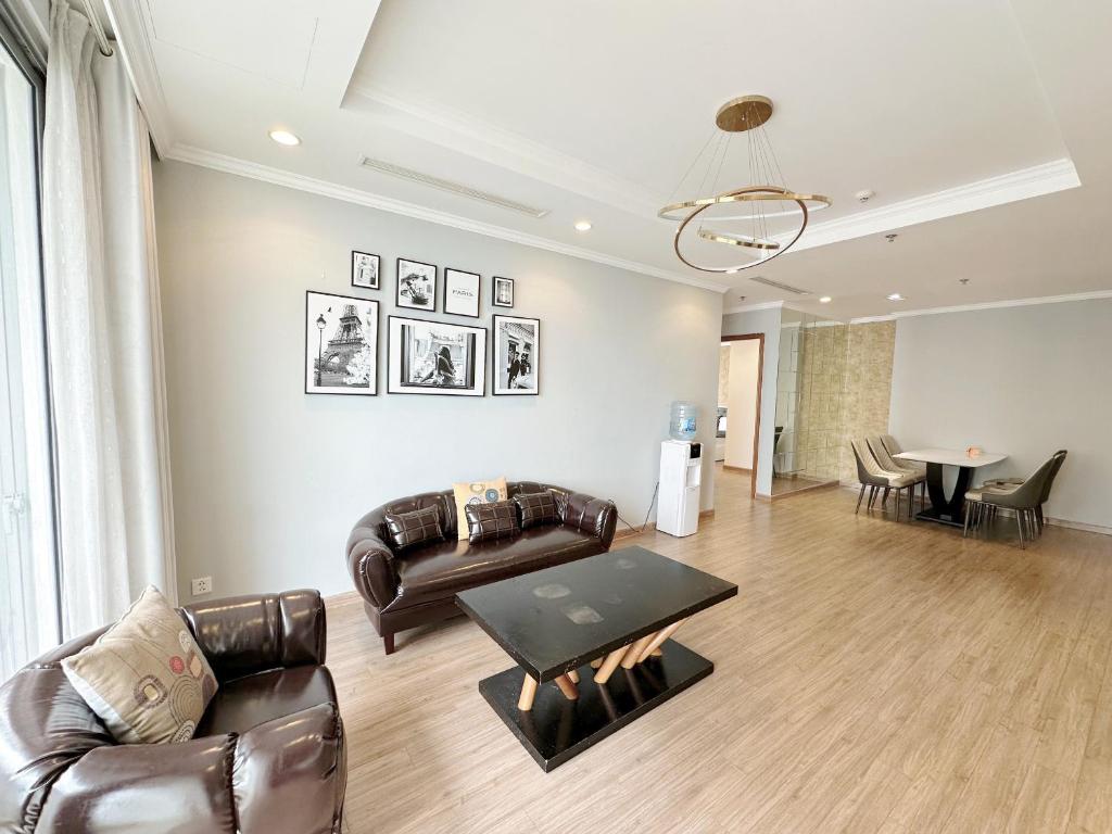 a living room with leather furniture and a table at City Center 4BR Apartment in Hanoi