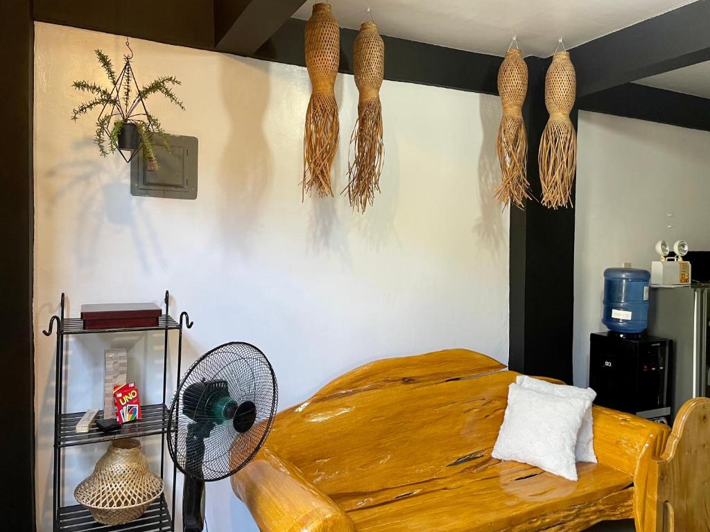 a bedroom with a bed with a fan and decorations at Casa Olivia in Coron