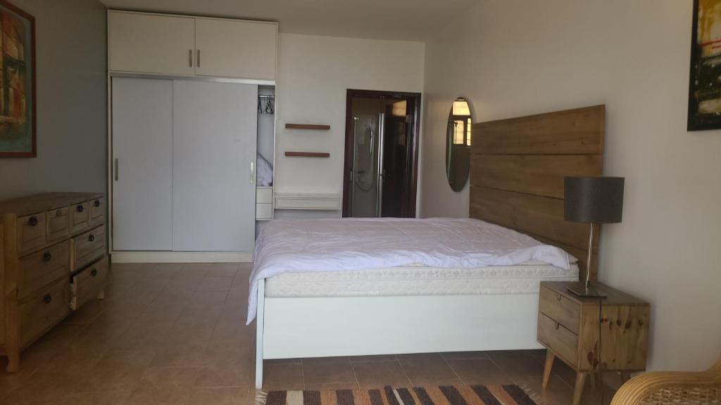 a bedroom with a bed and a dresser and a closet at Rubavu Buy And Sell Ltd, real estate agency in Gisenyi