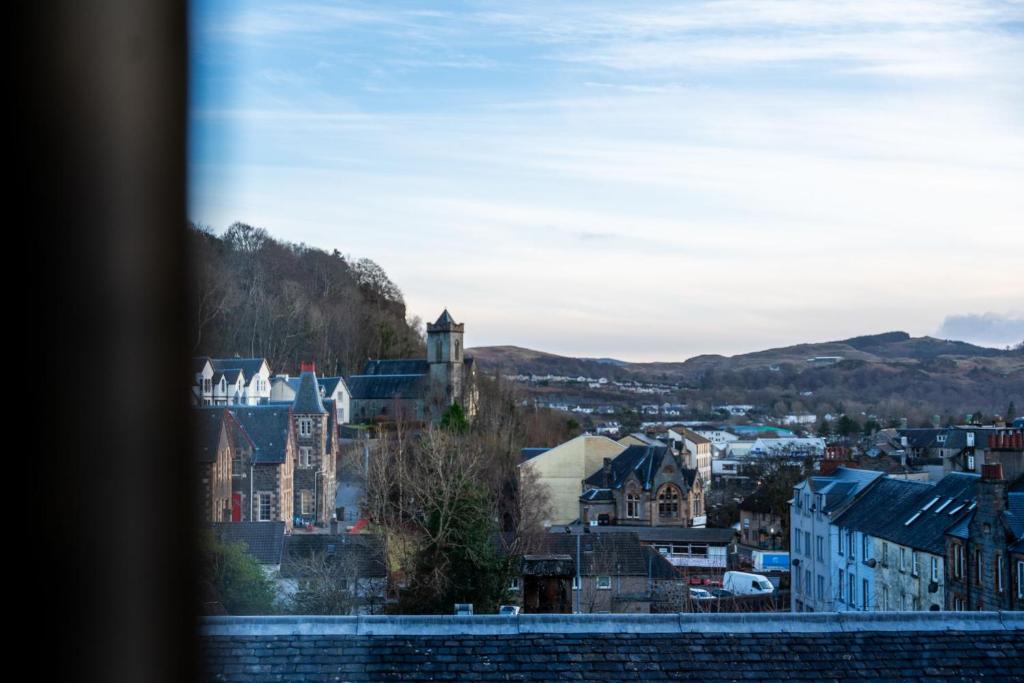 a view of a city from a window at Dalwhinnie Apartment in Oban