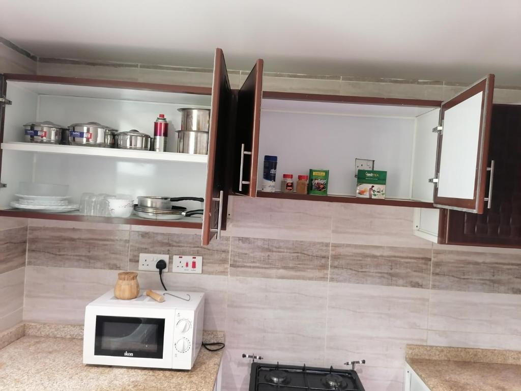 a kitchen with a microwave on a counter at الخوض السادسة واحة المعرفة in Al Khawḑ