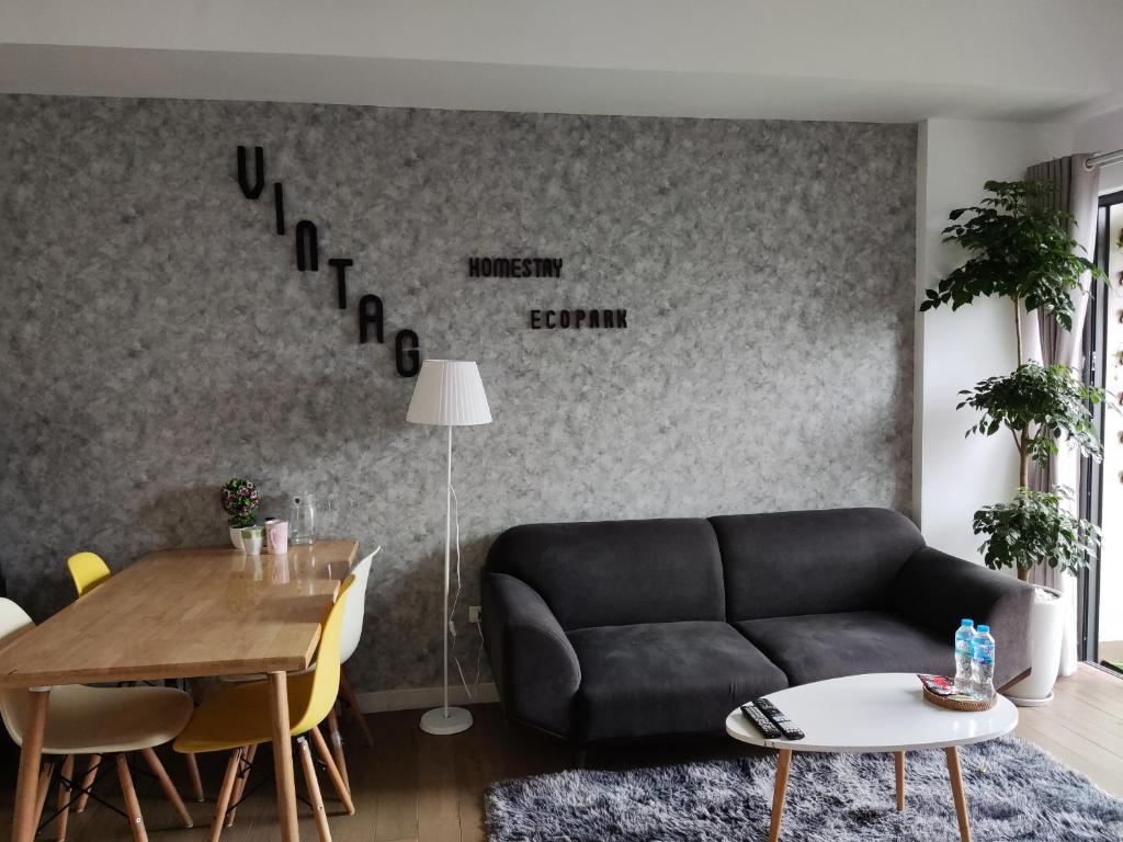 a living room with a couch and a table at H2 Homestay - Ecopark, Văn Giang, Hưng Yên in HÆ°ng YÃªn