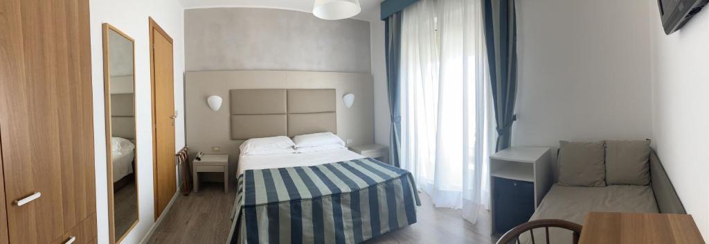 Postel nebo postele na pokoji v ubytování Hotel Sirenetta