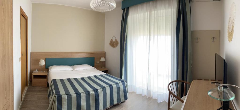 Postel nebo postele na pokoji v ubytování Hotel Sirenetta