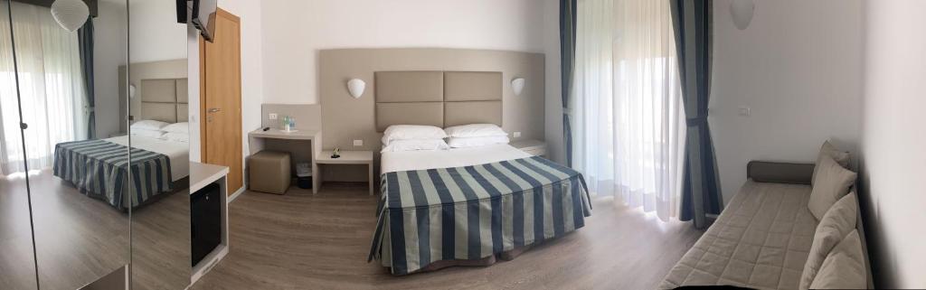 Postel nebo postele na pokoji v ubytování Hotel Sirenetta