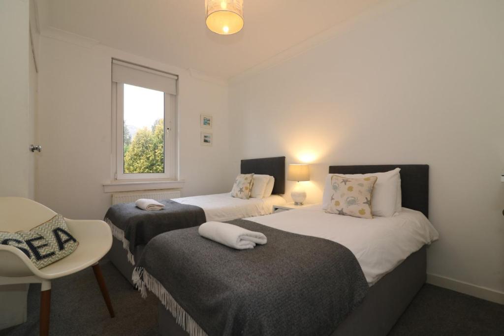 Ένα ή περισσότερα κρεβάτια σε δωμάτιο στο Signature - Bruce Terrace Upper - Blantyre