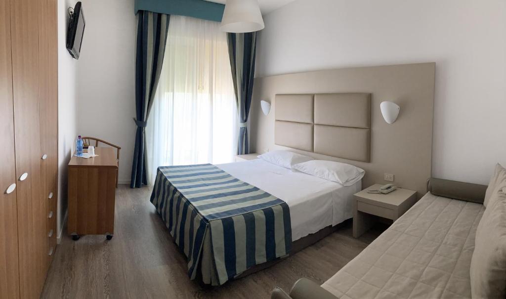 Postel nebo postele na pokoji v ubytování Hotel Sirenetta