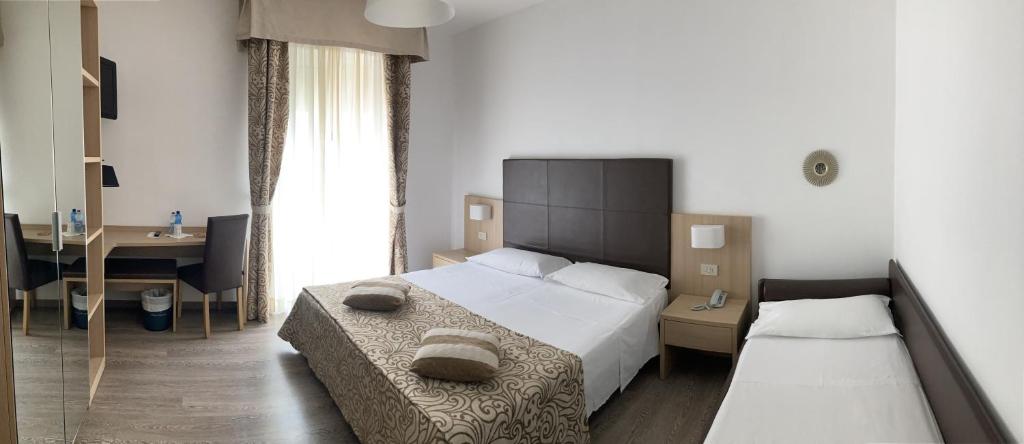 Postel nebo postele na pokoji v ubytování Hotel Sirenetta