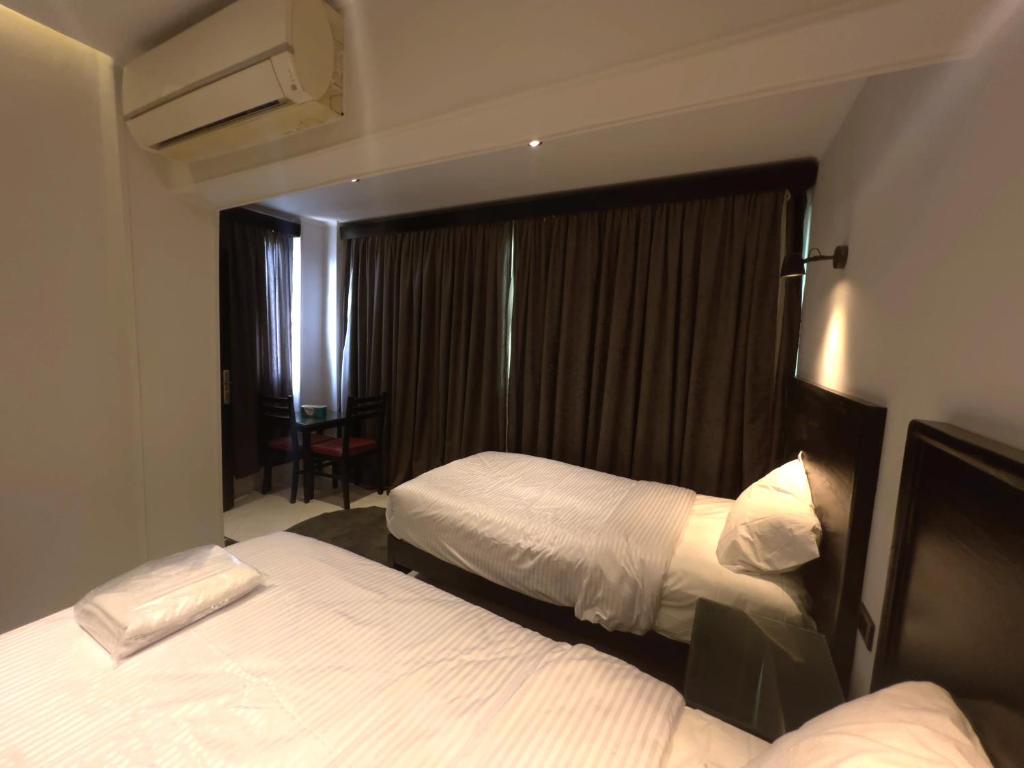 Postel nebo postele na pokoji v ubytování Helio Cairo Hotel