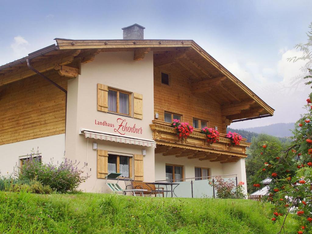 ein Gebäude mit einem Balkon mit Blumen darauf in der Unterkunft Landhaus Zehentner in Saalbach-Hinterglemm