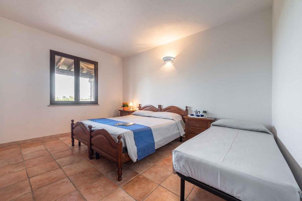 A bed or beds in a room at House and Apts. Siniscola/Sardinien 35758