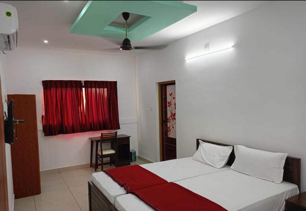 a bedroom with a bed with a green ceiling at Sky Residency Lodge in Trichūr