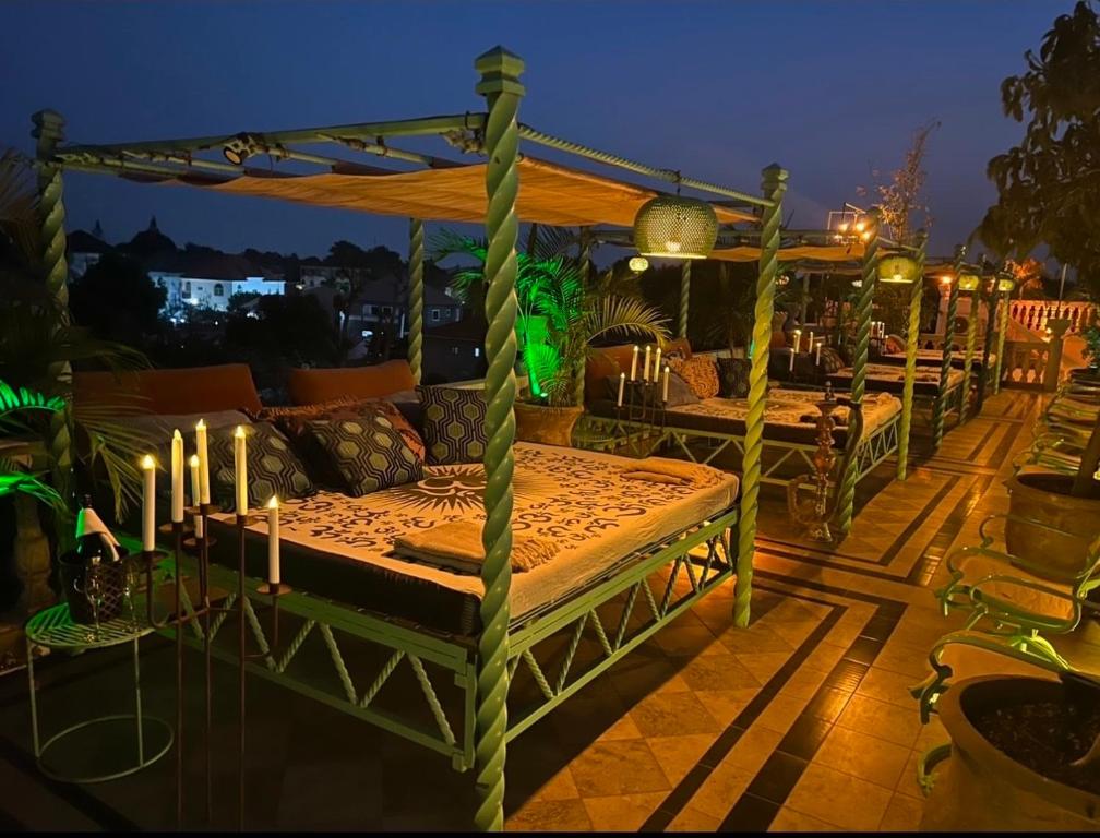 a bed sitting on top of a patio at night w obiekcie RoofTop Boutique Hotel Adults Only w mieście Serekunda