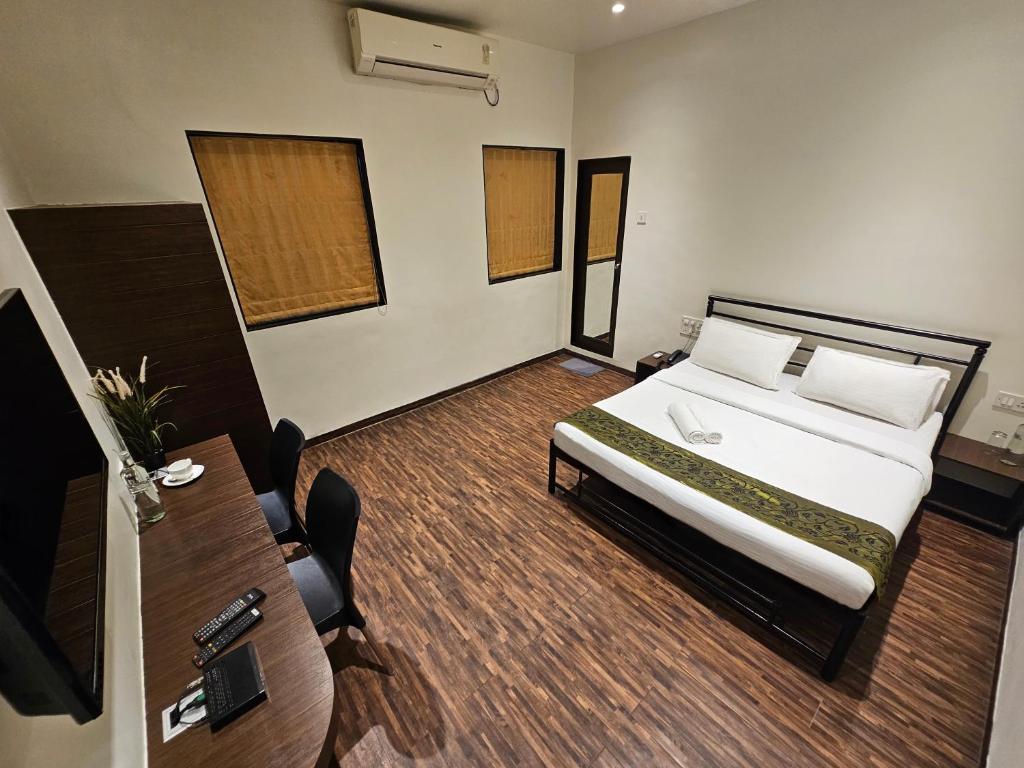 Postel nebo postele na pokoji v ubytování Hotel Kumkum