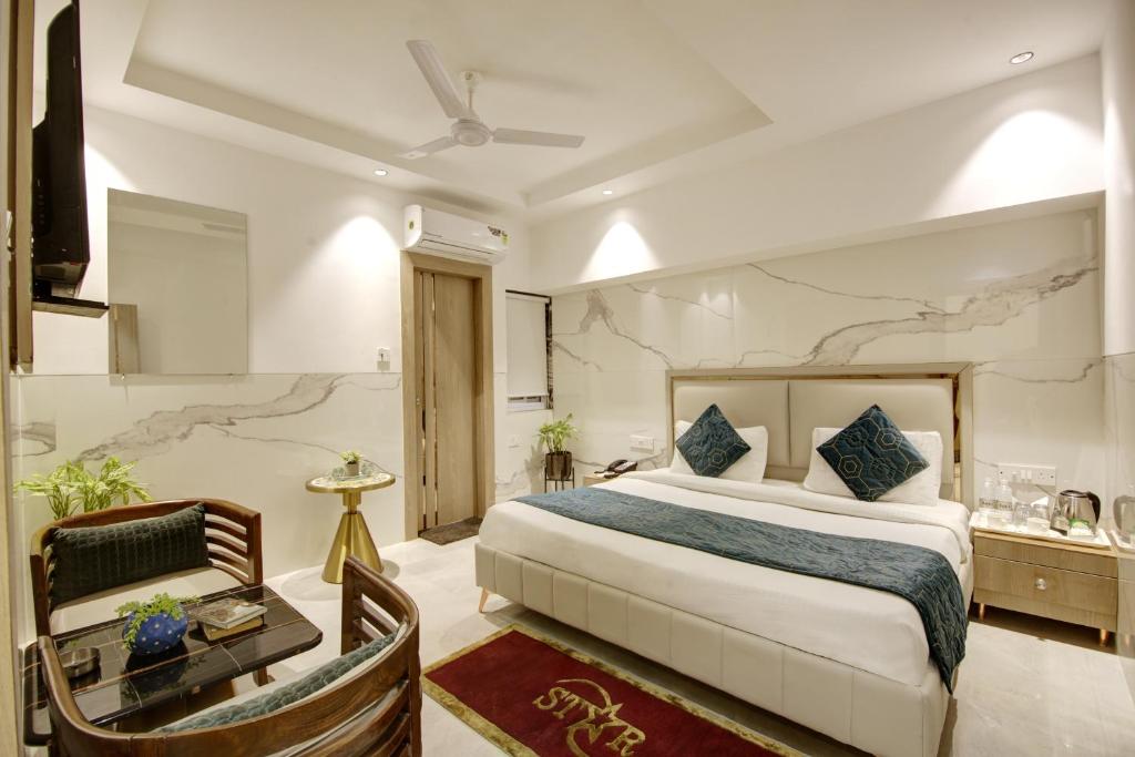 a hotel room with a bed and a desk and a room at Hotel International Inn - Near Delhi Airport in New Delhi