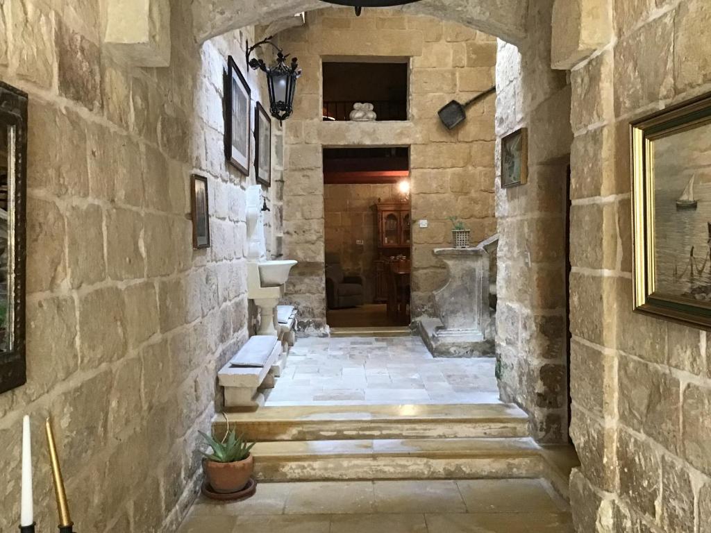 a hallway in a castle with a stone wall at Charming 17th Cent House of Character in the famous 3 Cities, right next to Valletta in Cospicua