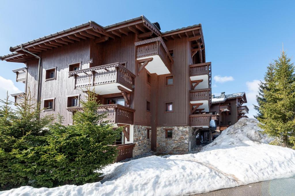 a large building with snow in front of it at Lapon H10 in Hauteluce