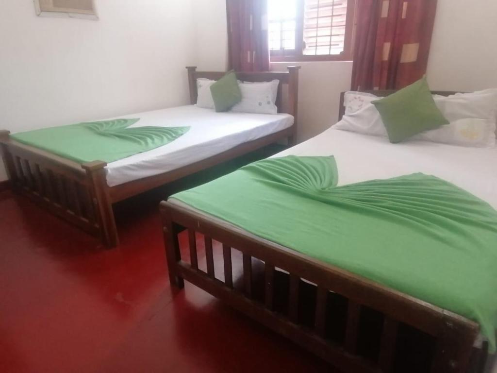 Postel nebo postele na pokoji v ubytování Sunshine Guest House
