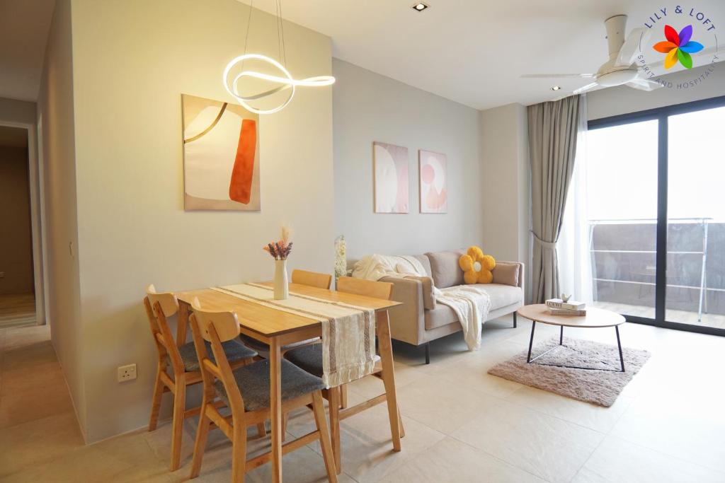 a living room with a table and a couch at Lumi Tropicana By LilyandLoft in Petaling Jaya