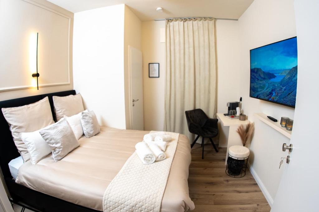 a hotel room with a bed and a desk at Angelinas Service Apartment 1 in Oberhausen