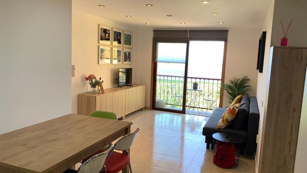 a living room with a table and a couch at Apartamento Los Guirres in Tazacorte