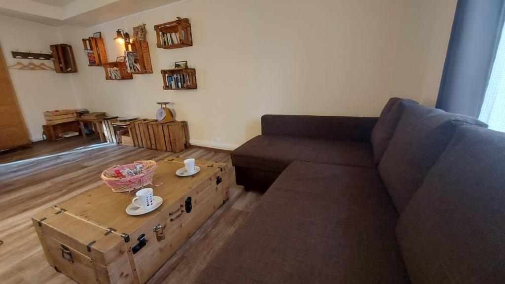 a living room with a couch and a coffee table at Studio cosy au cœur d'Honfleur in Honfleur