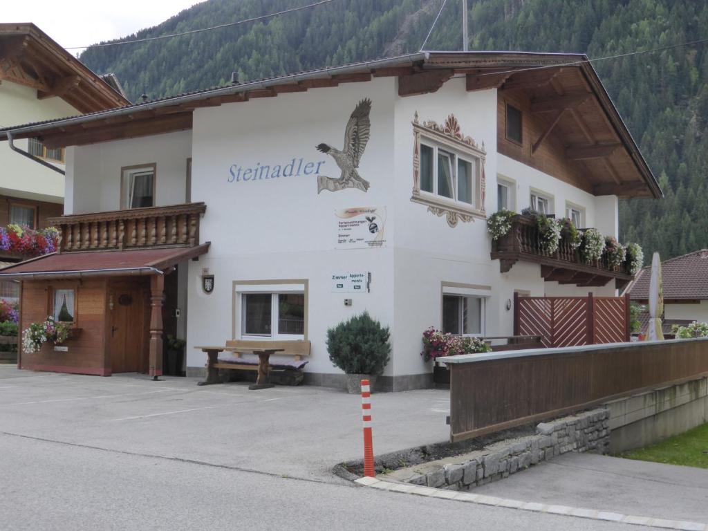 a building with a bird on the side of it at Pension Steinadler in Neustift im Stubaital