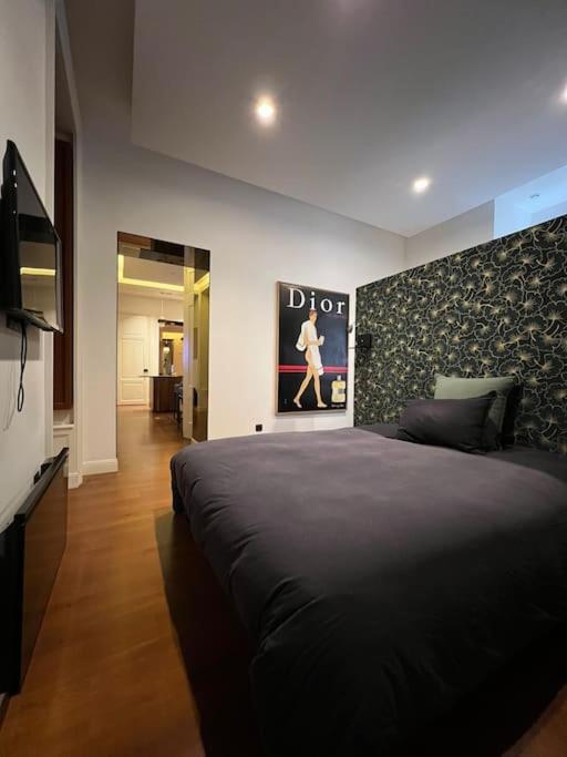 a bedroom with a large black bed in a room at Stunning apartment in the center of Lyon ! in Lyon