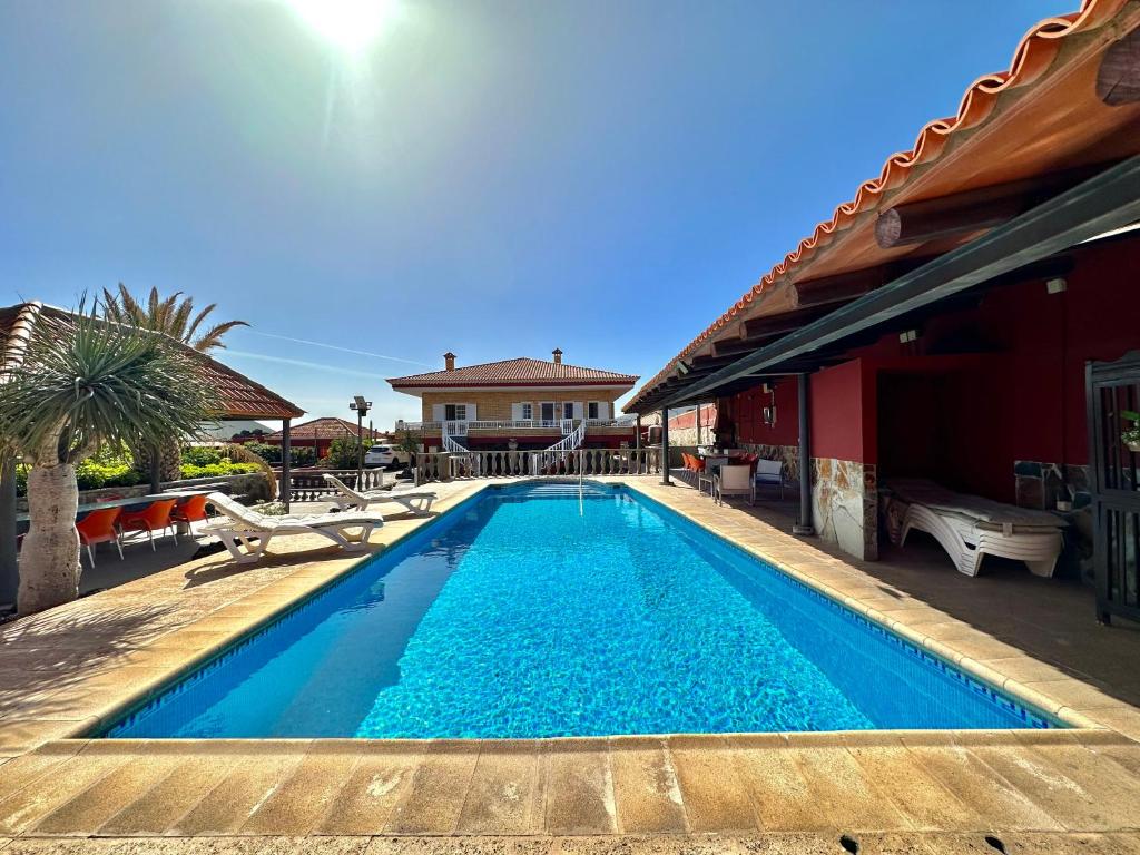 a swimming pool in front of a house at Villa Puntallana in Arafo