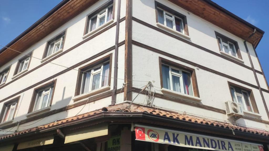a tall white building with windows on a street at YASİN OTEL in Konya