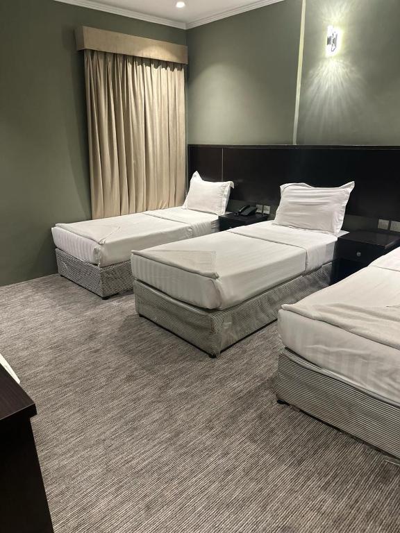 Postel nebo postele na pokoji v ubytování فندق كنان العزيزية Kinan Al Azizia Hotel Makkah