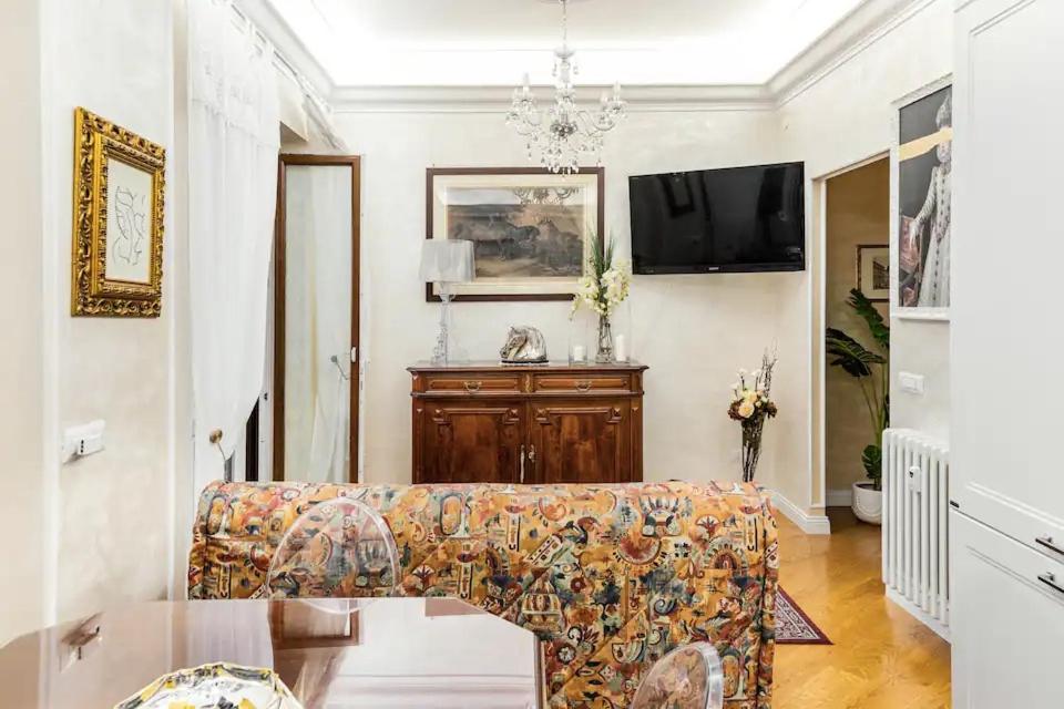 a living room with a couch and a flat screen tv at Menotti elegant Apartment in Rome