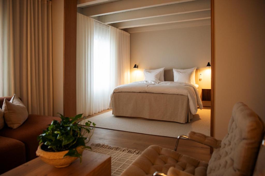 a bedroom with a bed and a large mirror at Hotel Vyn in Simrishamn