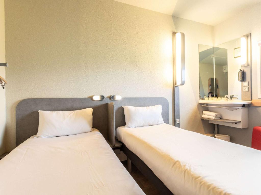 Postel nebo postele na pokoji v ubytování ibis budget Bourges