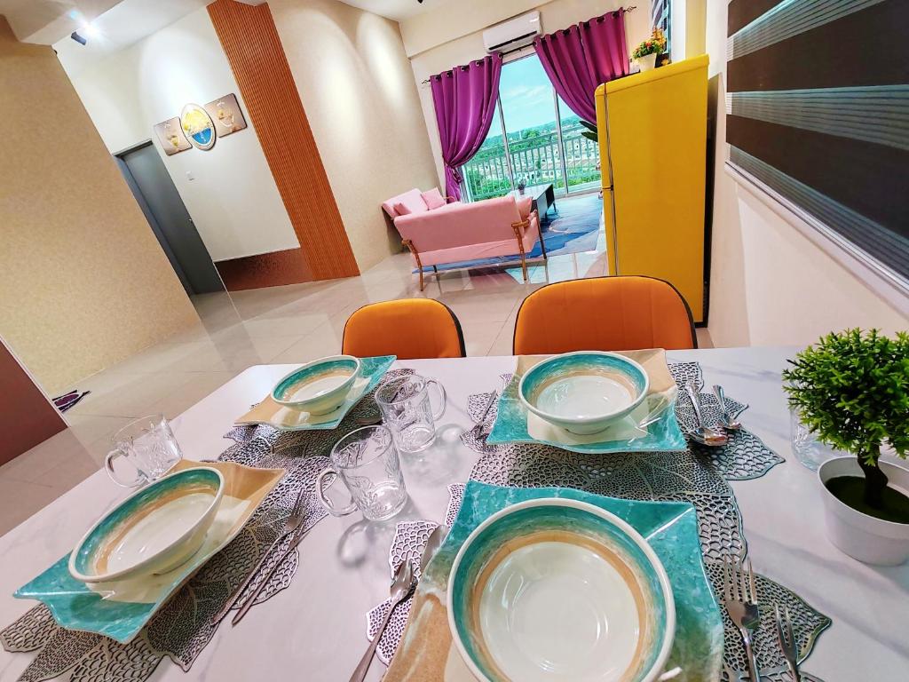 una mesa con platos y vasos encima en Pavilionvillie M1T692 by irainbow en Ipoh
