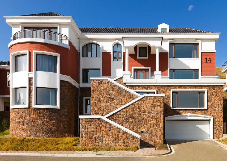 a large brick house with a white at Luxury House at Xanadu Residence in Ulaanbaatar