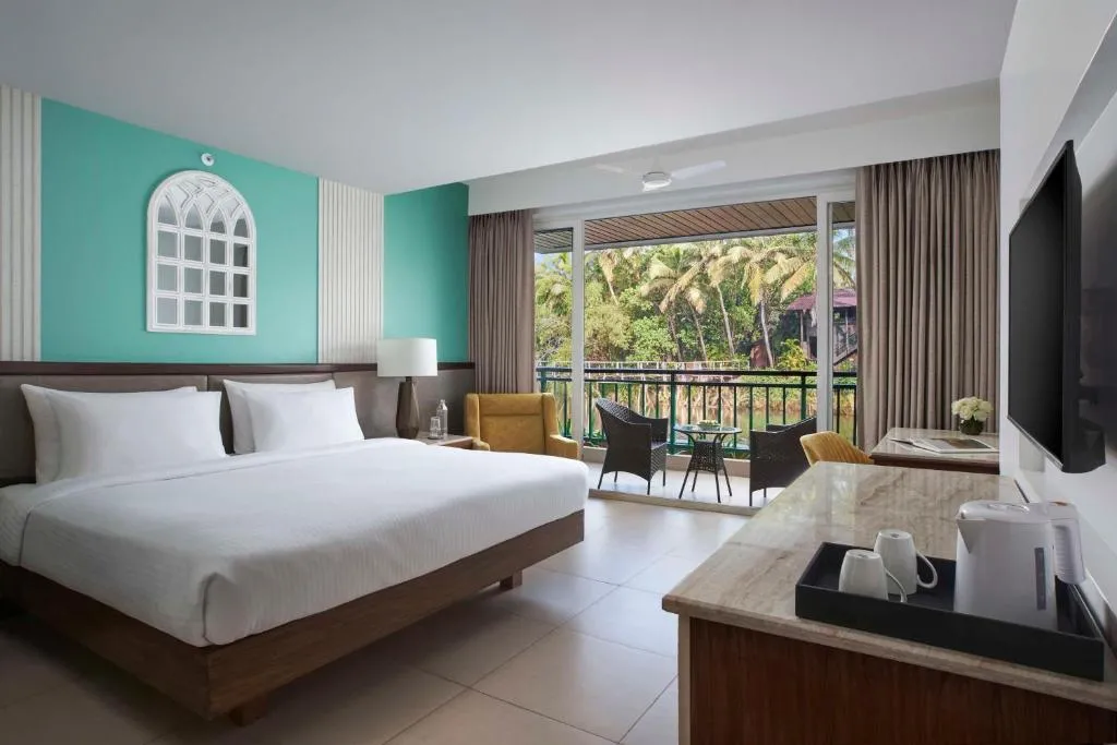 Deluxe Room with River View & Balcony - 1 child below 12 stays for free (upto March 2027 check-in) + Beer on arrival + Happy Hours (6-8PM) - INR 500 Credit for Food & Soft Beverages per room per stay (Cannot be clubbed with Happy Hours)