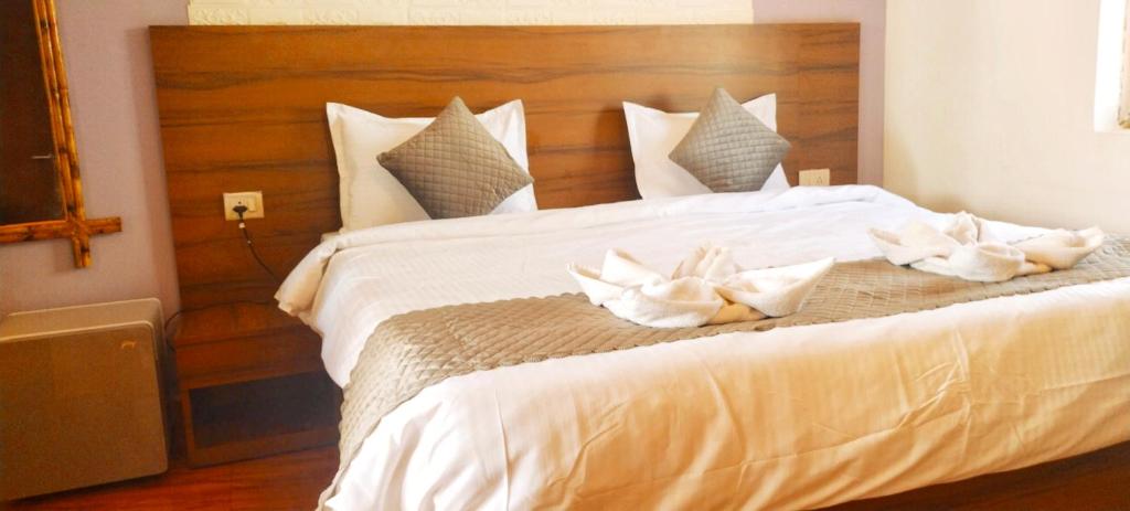 a bedroom with a large white bed with white pillows at Calangute Beach Front in Calangute