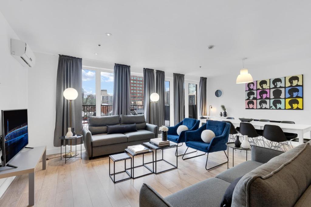 a living room with a couch and a tv at LiV MTL Downtown in Montréal