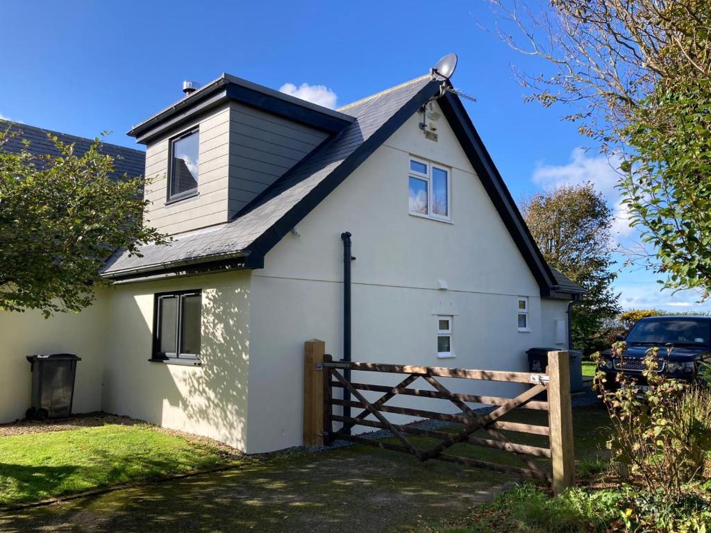 a white house with a black roof at The Annex, Escape to the Country in Salcombe