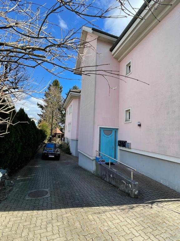 a car parked next to a pink building at MBudget free Parking in Graz