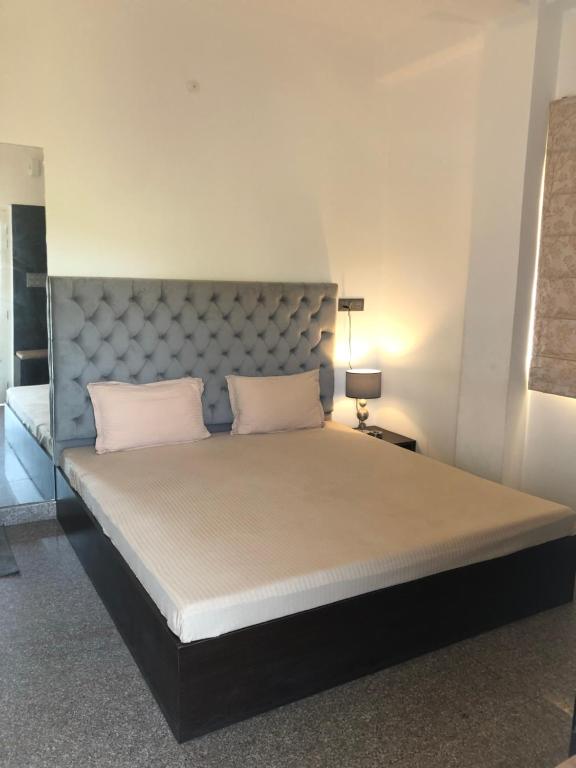 a large bed with two white pillows in a room at Anne’s Laces Homestay in Guwahati