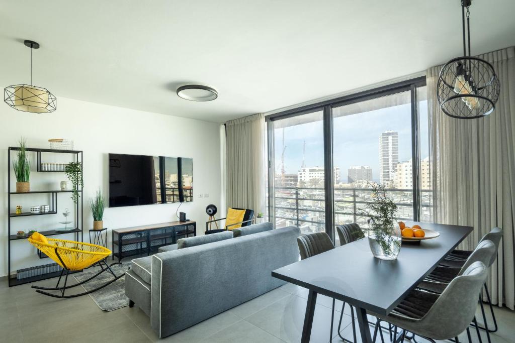 a living room with a couch and a table at HaCarmel Market Vibrat Apartment by Sea N' Rent in Tel Aviv