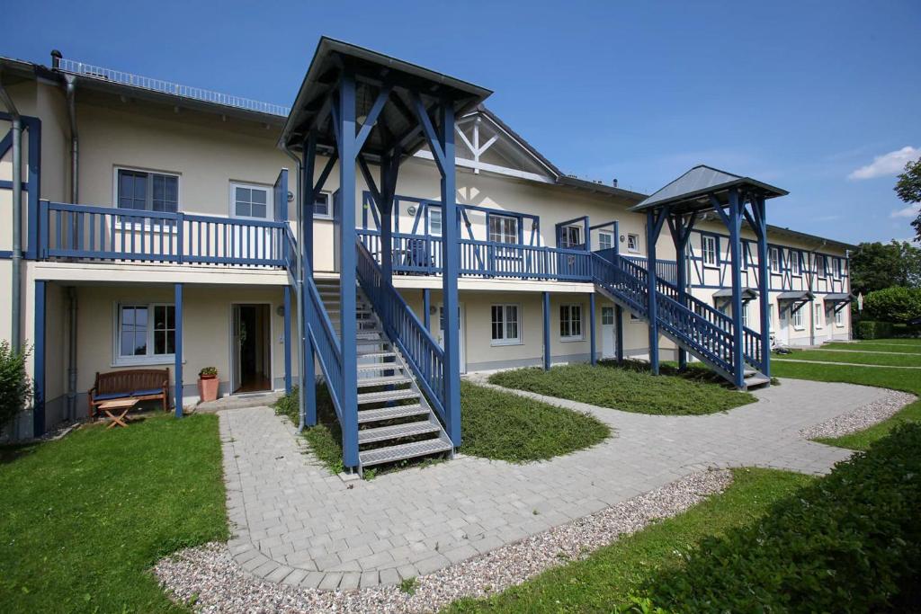 a building with blue stairs in front of it at Landhaus Kaiser zum Strande - b47256 in Bastorf