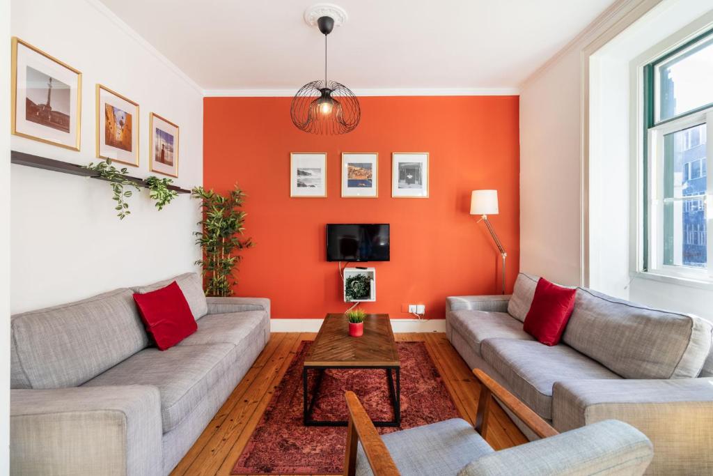 a living room with two couches and a table at Inglaterra by Central Hill Apartments in Lisbon