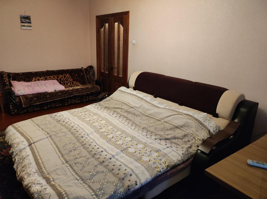a bed with a blanket on it in a room at Hotels in Orhei
