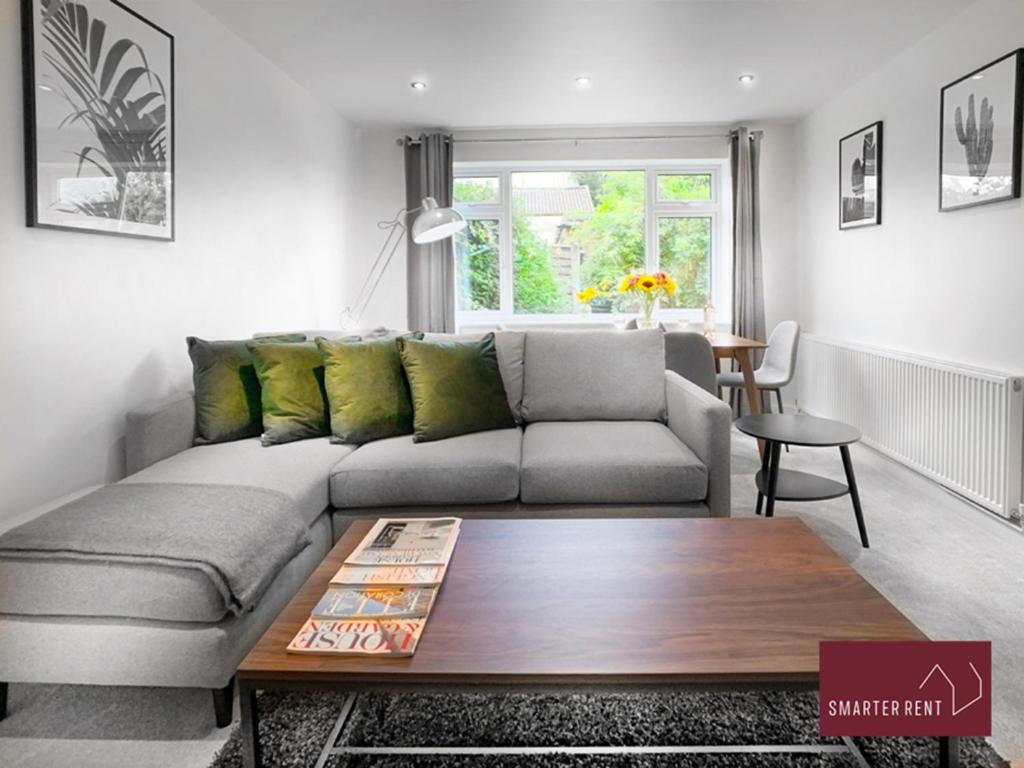 ein Wohnzimmer mit einem Sofa und einem Tisch in der Unterkunft Sunninghill Village - 2 Bed - Parking and garden in Ascot