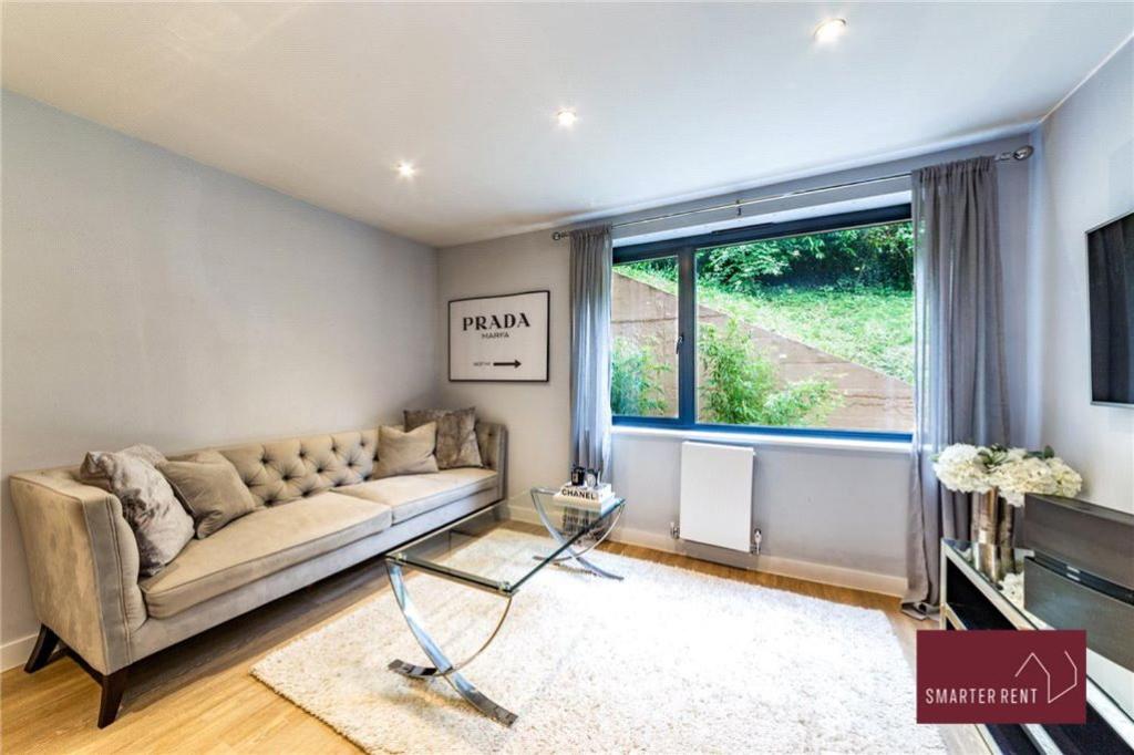a living room with a couch and a large window at Wooburn Green - Modern One Bedroom Apartment in Bourne End
